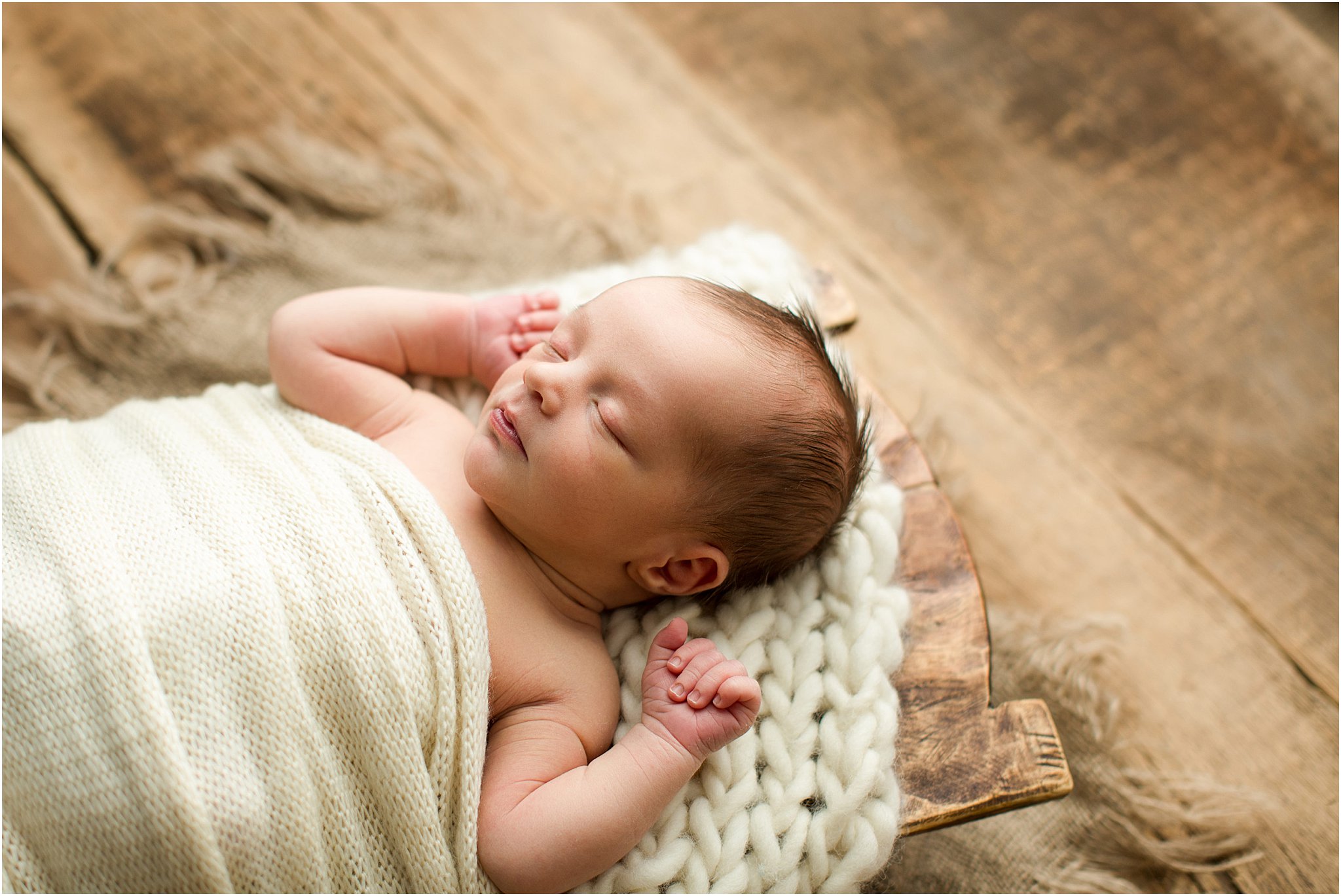 newborn baby in wooden trencher