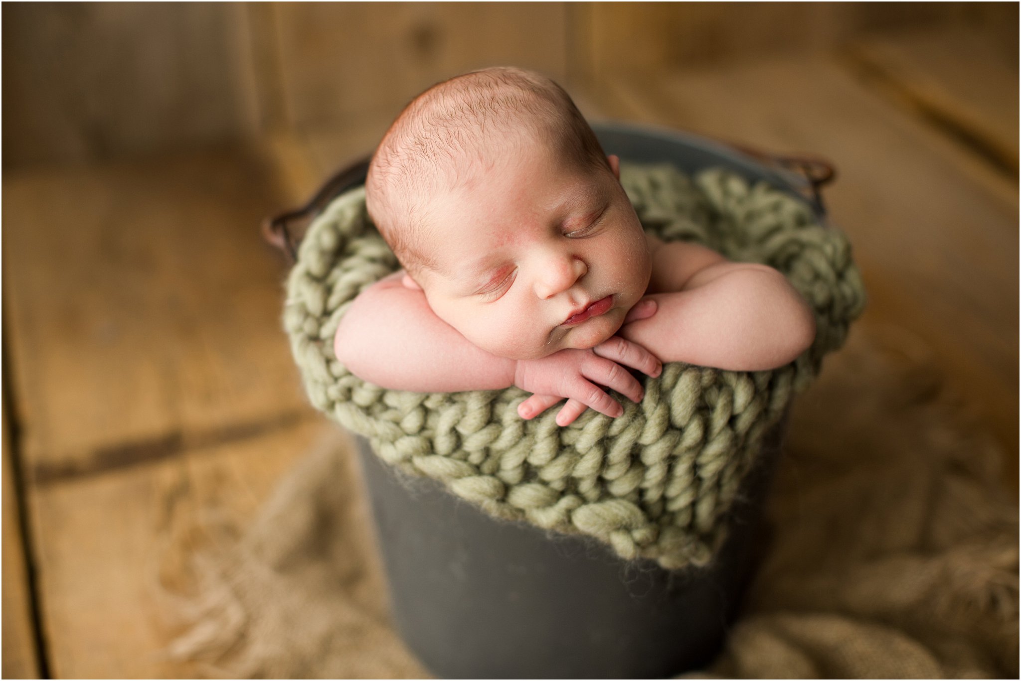 baby boy in bucket with green knit layer