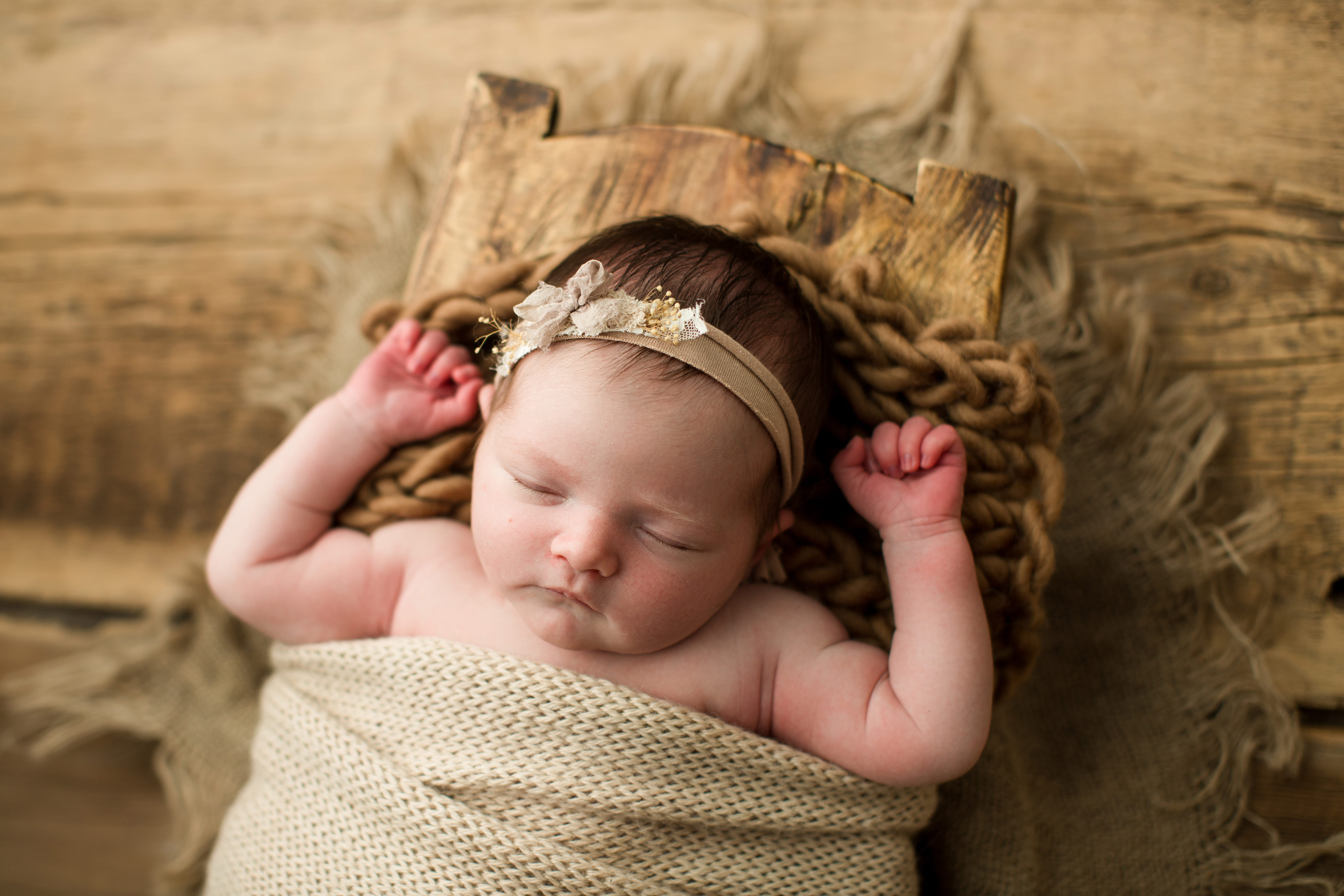 newborn girl Henley in wooden trencher with tan wrap