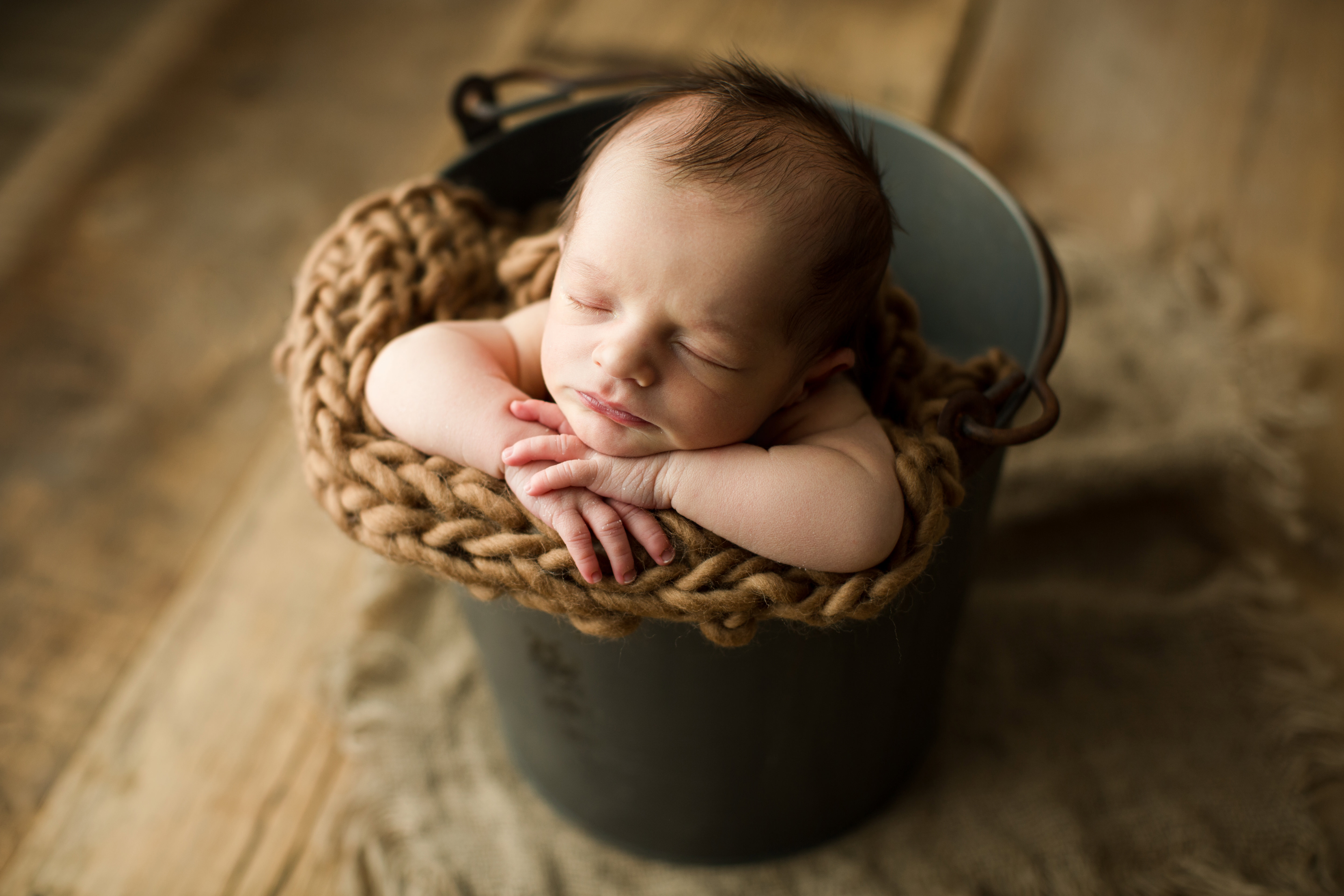 newborn baby boy in a bucket