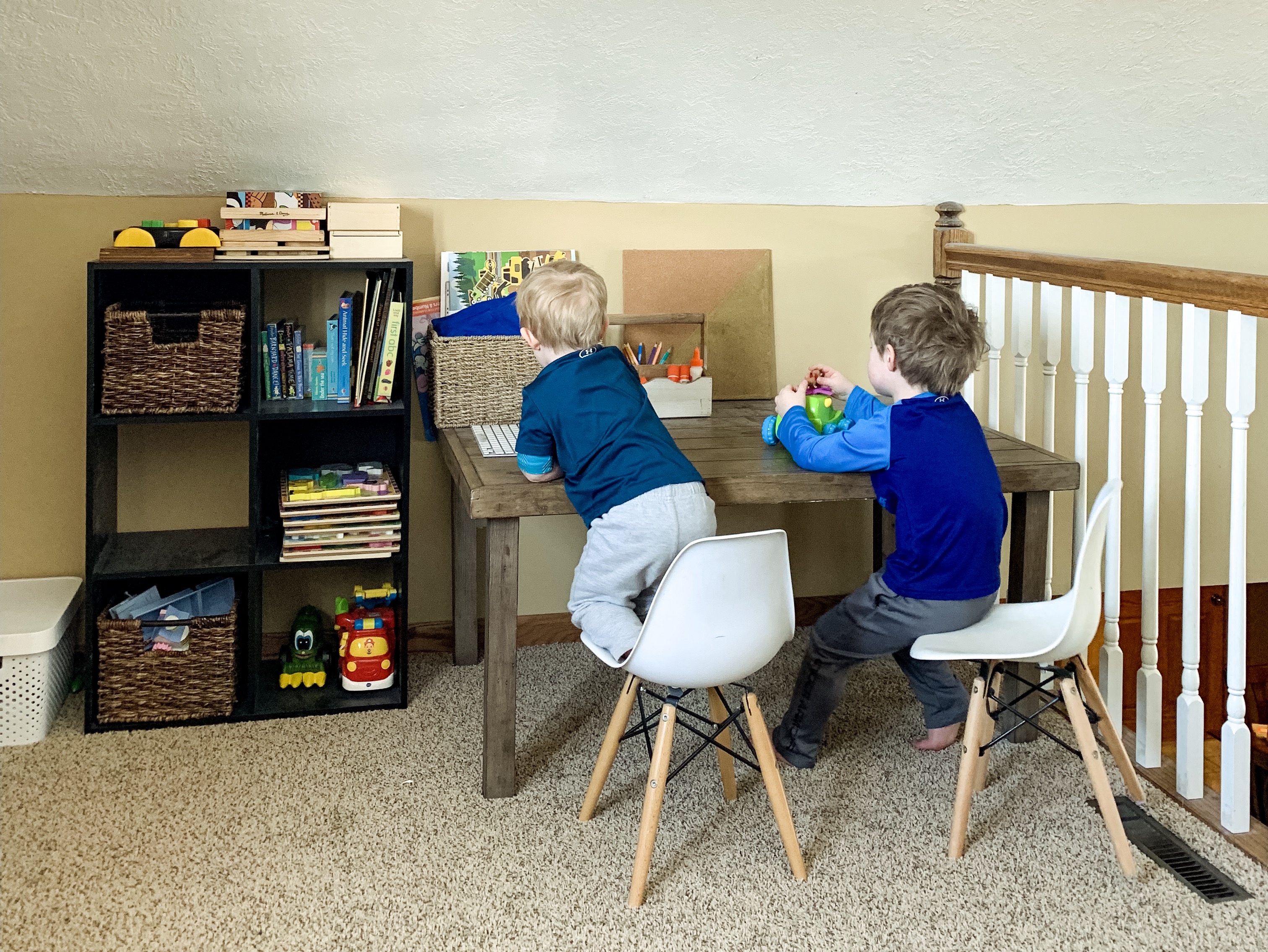 two boys playing at a desk
