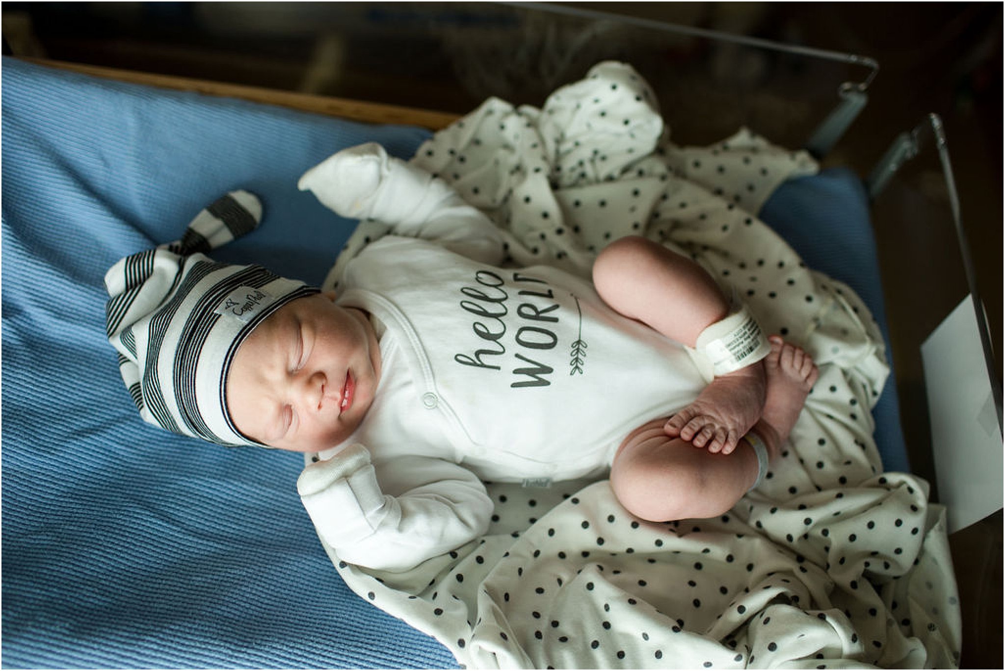 chubby newborn baby boy with striped hat