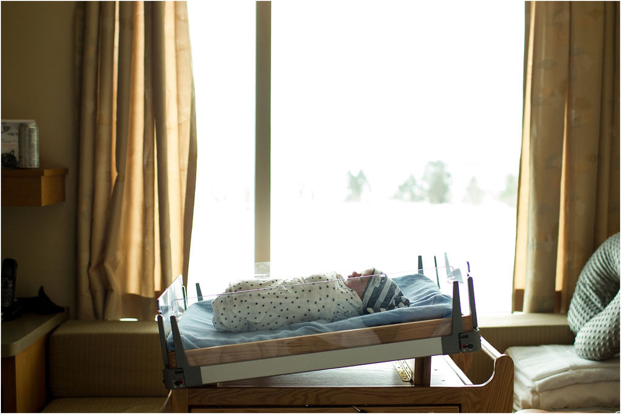 Newborn boy in hospital bassinet