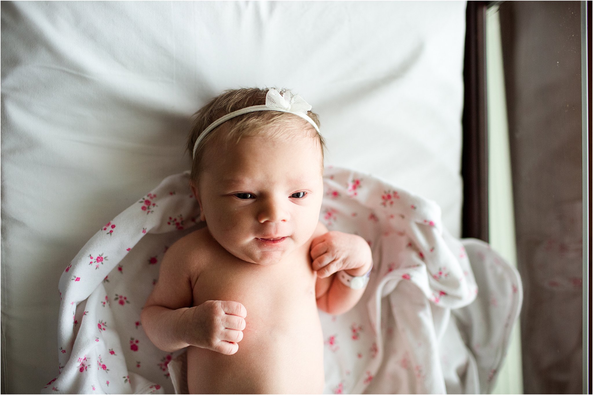 awake newborn baby girl in hospital