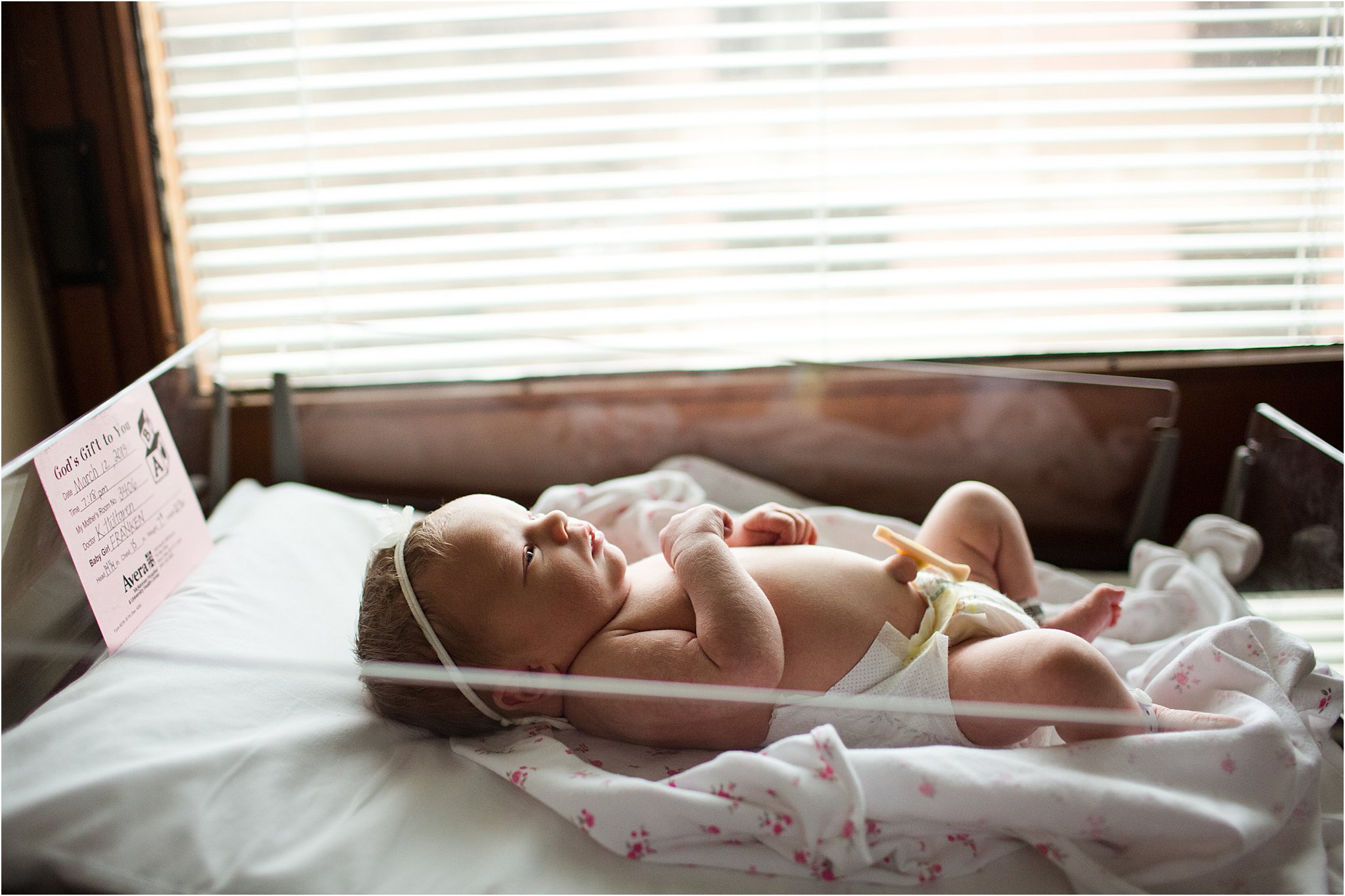 fresh baby in hospital bassinet