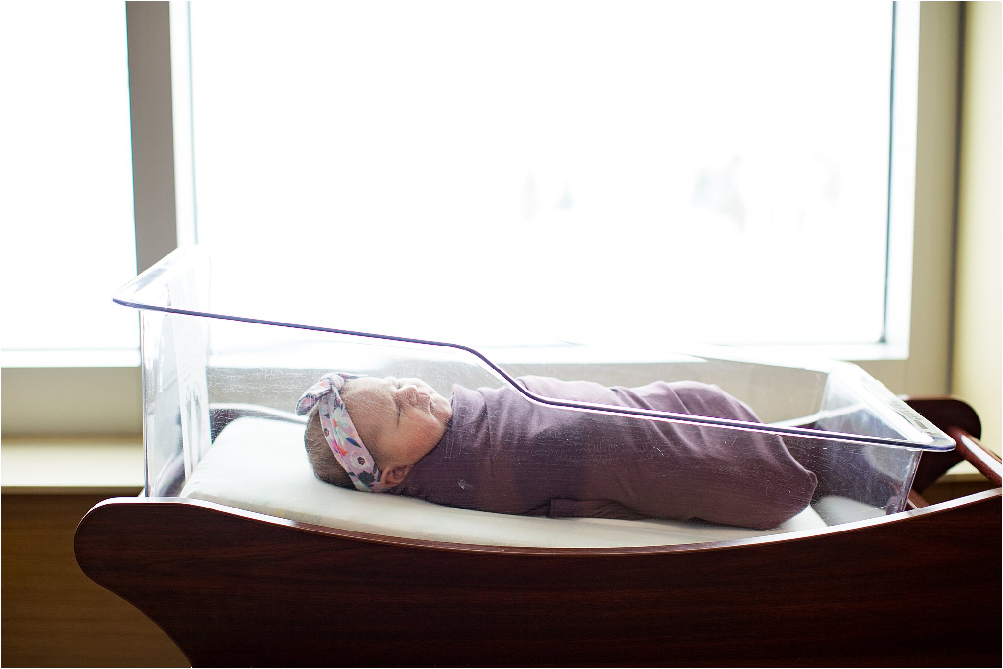 baby girl in hospital bassinet swaddled
