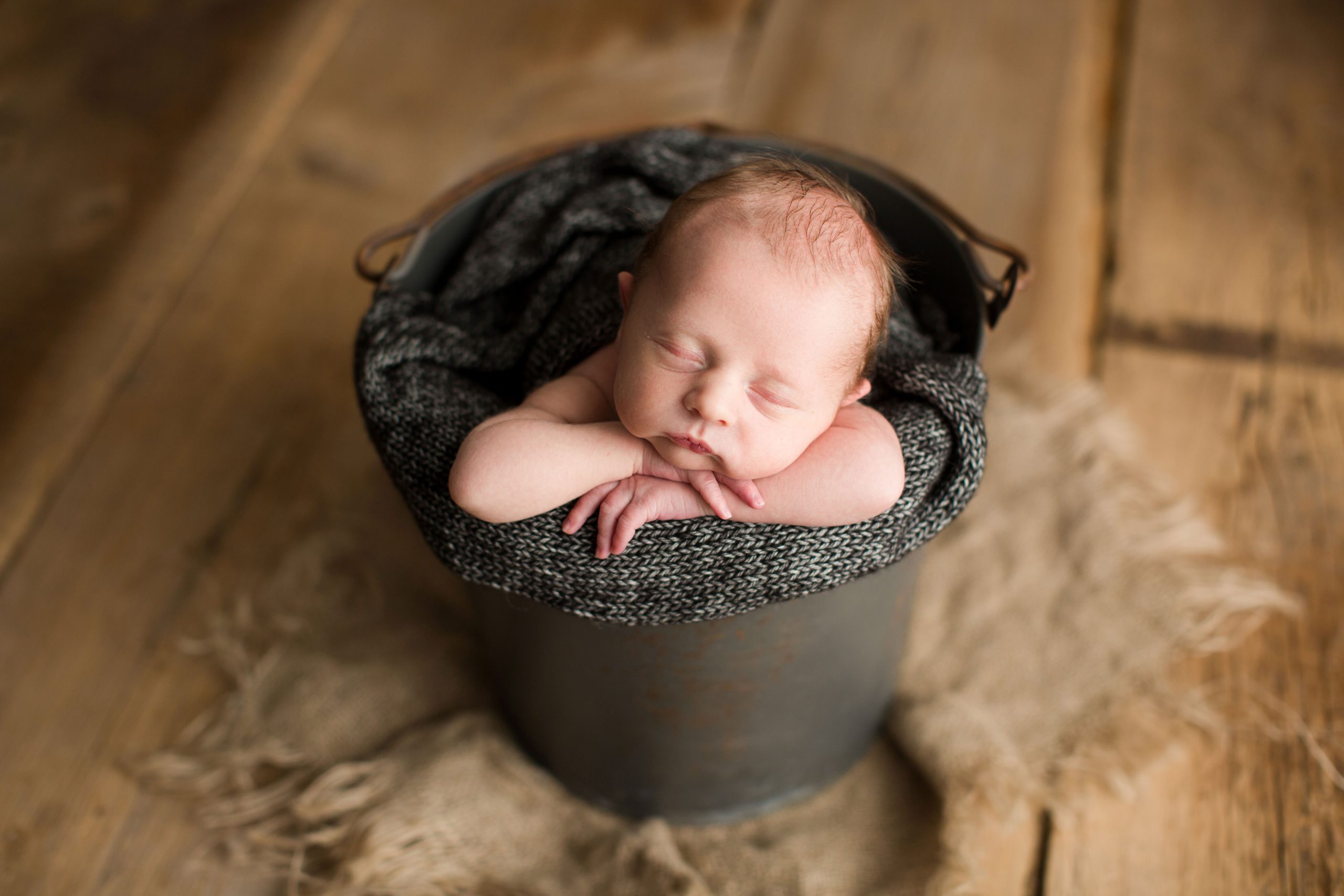 baby boy in charcoal bucket