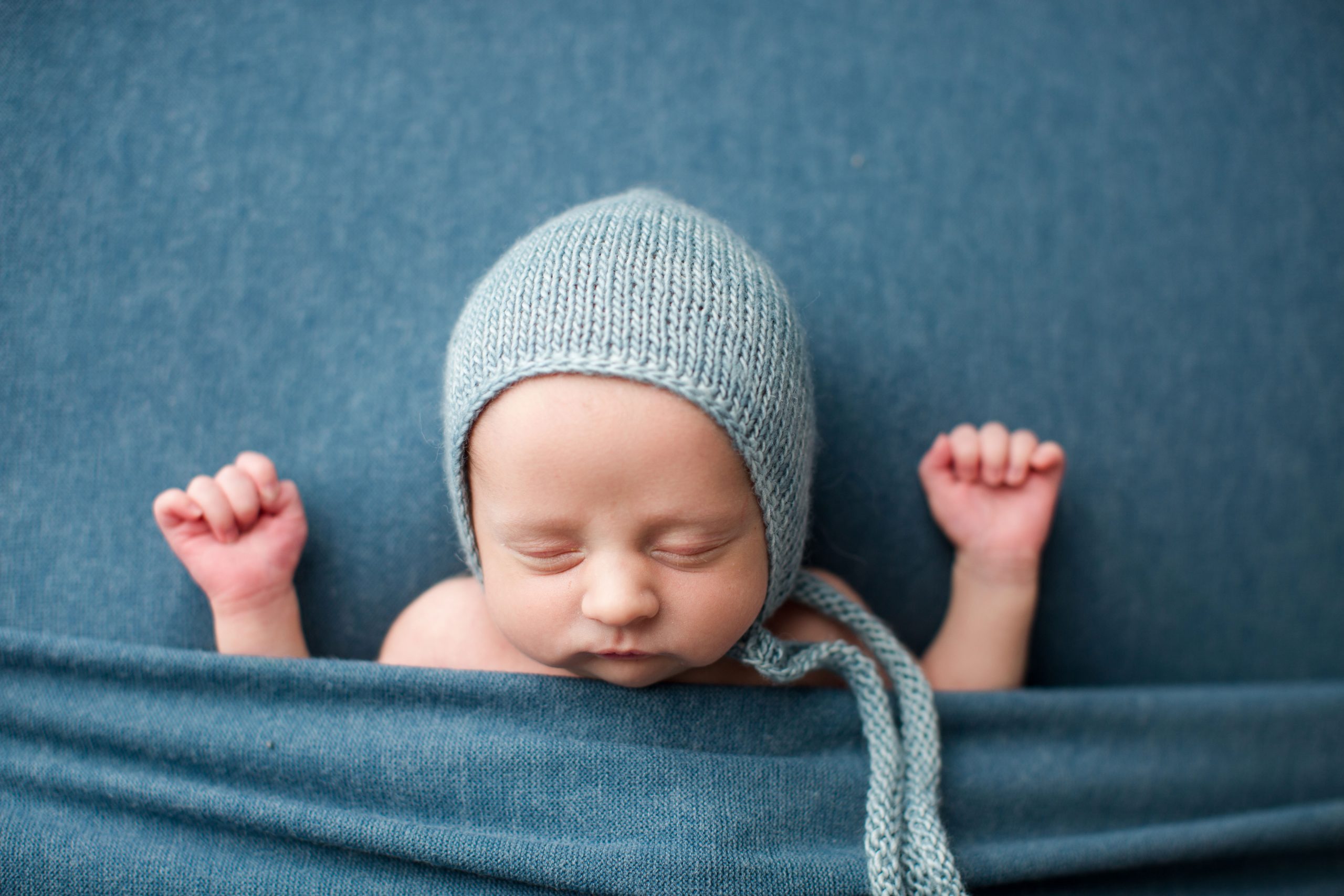 newborn boy tucked in pose