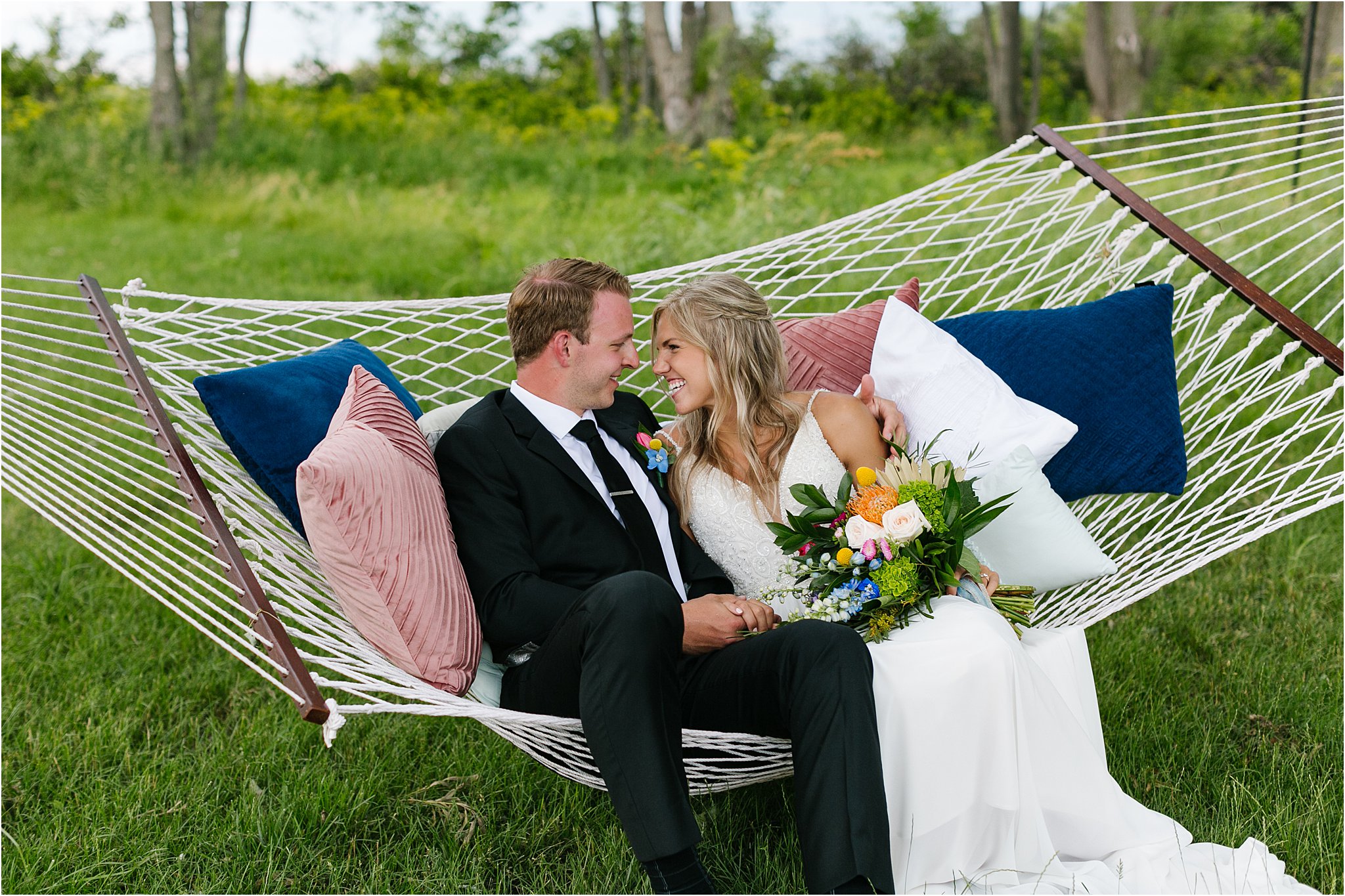 bride and groom snuggling in hammock